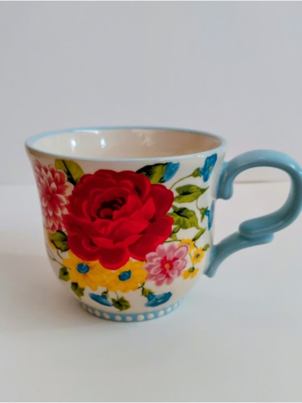 Ceramic Floral Mug with Blue Handle and Red Rose Accent